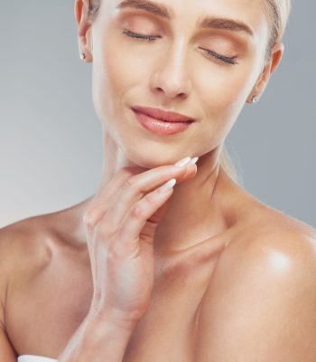 Beauty, skincare and face of a woman in studio for health, wellness and self care with cosmetics, makeup and dermatology product. Model posing for luxury facial, natural glow skin and self love.