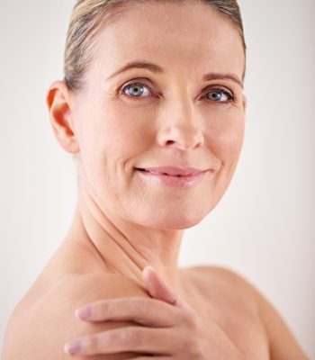 Model, smile and studio with skincare, portrait and cosmetic with treatment. Mature woman, beauty and luxury with body, cosmetics and care for anti ageing and healthy skin for wellness and confidence.