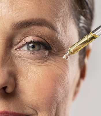 smiley-elder-woman-using-serum-her-eye-wrinkles