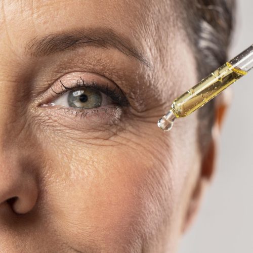 smiley-elder-woman-using-serum-her-eye-wrinkles