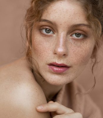 woman-with-pink-sweater-naked-shoulder