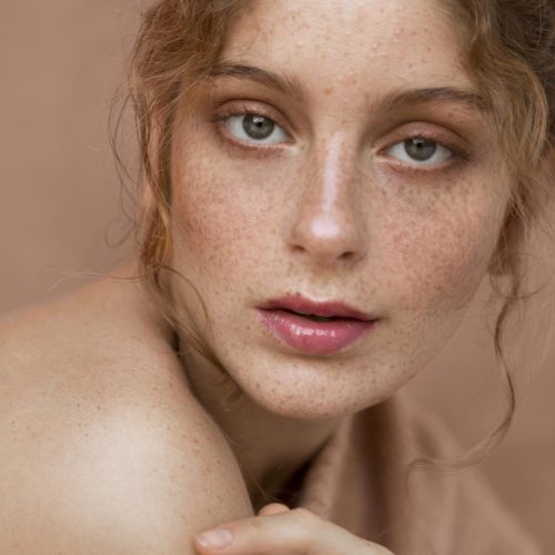 woman-with-pink-sweater-naked-shoulder